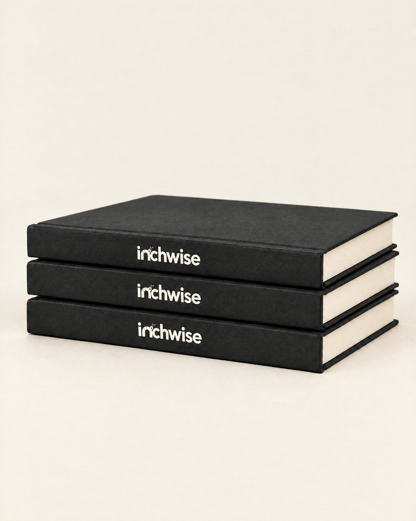 Three Inchwise journals stacked, spines showing
